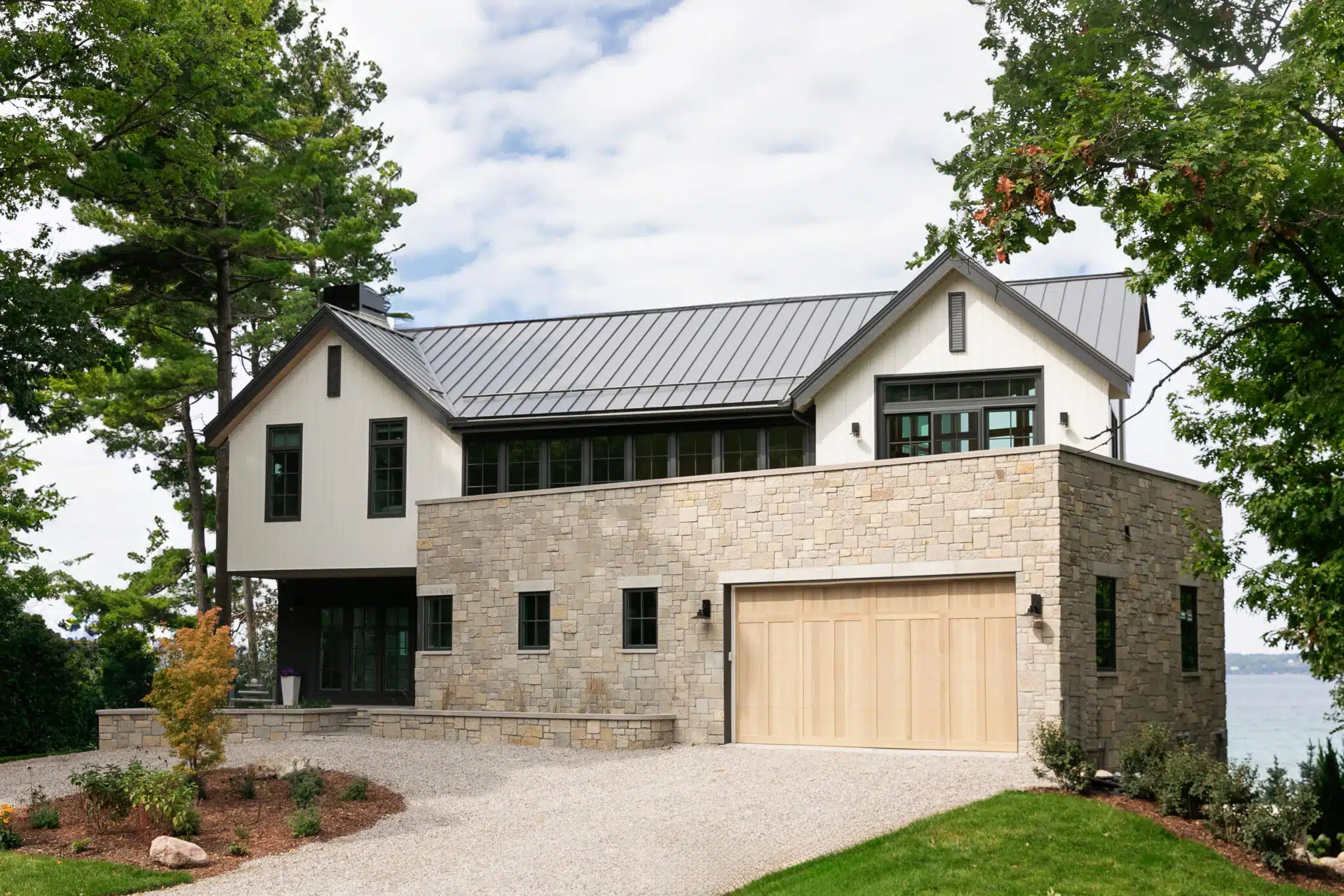 Lakefront home with black standing seam metal roof in Old Mission, MI